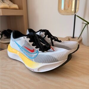 Nike Women's White Running Shoes with Yellow Midsole and Red/Blue Swoosh